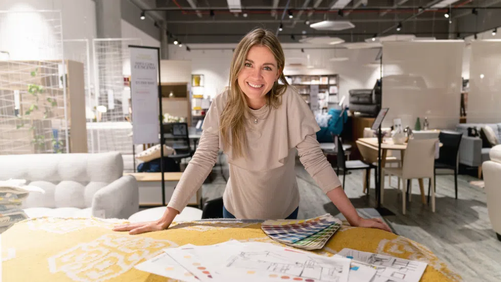 Designer at table with paint samples and design materials