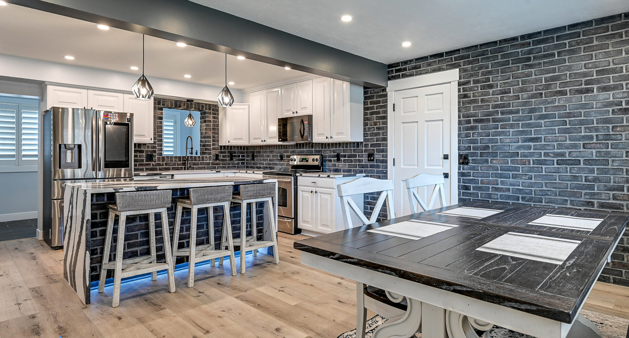 When PBS launched This Old House in 1979, it was one of the first home renovation shows available on TV. Over the next forty-five years, viewers have had more than a hundred different home improvement shows to choose from, including Dream Home Makeover, Kitchen Glow Up, Mountain Remodel, and Rescue My Renovation. Perhaps you’ve watched some home renovation shows and thought of some changes you’d like to see around your own home. Do you try tackling it yourself? Probably not if you’ve been watching Help! I Wrecked My House. So who should you hire? A home remodeling contractor? A home renovation professional? Does renovate mean the same thing as remodel? Is an expert in one automatically an expert in the other? Renovating and remodeling do have unique meanings. Here’s what you need to know about each one. Renovating Definition: Renovating is about updating, improving, or modifying a space without making major structural changes. Scope: Renovation typically involves projects such as repainting walls, replacing cabinets, updating fixtures, refinishing floors, or upgrading appliances. Goal: The goal of a renovation is to improve the comfort, usability, or style of a home without altering the existing layout. Example: Below are before and after photos of a kitchen renovation Utah Home Remodel Experts completed in Sandy, UT. The layout of the room is unchanged, but we repainted the door and cabinetry, changed the look of the walls and kitchen island with a faux brick design, replaced the original countertops with ones imported from Europe, and added pendant light fixtures over the island. Remodeling Definition: Remodeling involves changing the structure or layout of a space, often with a significant redesign. Scope: Remodeling projects are usually larger and more complex, as they can involve moving walls, adding windows, changing room configurations, or building entirely new spaces. Goal: The goal of a remodel is to transform a space to serve a new function or aesthetic. Example: Below are before and after photos of a kitchen remodel Utah Home Remodel Experts completed in Holladay, UT. The extensive changes included removing walls to open up the kitchen to the rest of the main level, reflooring the now unified space, major electrical upgrades and plumbing reroutes to move the location of the sink and add a kitchen island with pendant lights and built-in appliances, and completing the new chic aesthetic with white quartz countertops and shaker-style cabinets with brushed gold finishes. The Most Important Thing To Remember Renovating is making something old feel new while remodeling is transforming something old into something new. But while there is technically a difference between the two terms, in reality, they are used interchangeably among the home improvement community. So it doesn’t matter whether you call us your glow-up gurus, makeover masters, renovation specialists, or remodeling experts–all that matters is that you call us. Because at Utah Home Remodel Experts, we don't care what terms you use; we only care about bringing your vision for your living space to life.