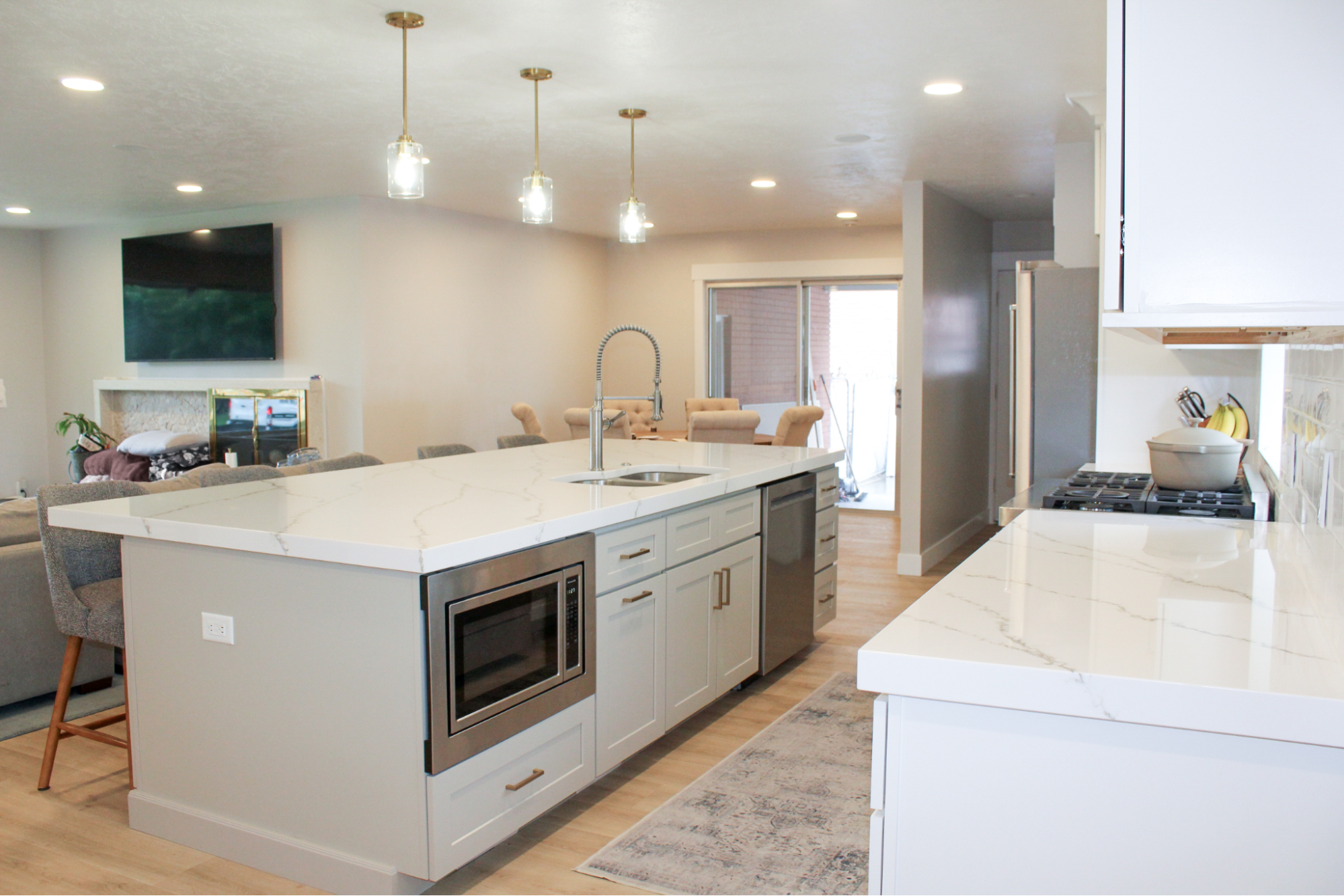 When PBS launched This Old House in 1979, it was one of the first home renovation shows available on TV. Over the next forty-five years, viewers have had more than a hundred different home improvement shows to choose from, including Dream Home Makeover, Kitchen Glow Up, Mountain Remodel, and Rescue My Renovation. Perhaps you’ve watched some home renovation shows and thought of some changes you’d like to see around your own home. Do you try tackling it yourself? Probably not if you’ve been watching Help! I Wrecked My House. So who should you hire? A home remodeling contractor? A home renovation professional? Does renovate mean the same thing as remodel? Is an expert in one automatically an expert in the other? Renovating and remodeling do have unique meanings. Here’s what you need to know about each one. Renovating Definition: Renovating is about updating, improving, or modifying a space without making major structural changes. Scope: Renovation typically involves projects such as repainting walls, replacing cabinets, updating fixtures, refinishing floors, or upgrading appliances. Goal: The goal of a renovation is to improve the comfort, usability, or style of a home without altering the existing layout. Example: Below are before and after photos of a kitchen renovation Utah Home Remodel Experts completed in Sandy, UT. The layout of the room is unchanged, but we repainted the door and cabinetry, changed the look of the walls and kitchen island with a faux brick design, replaced the original countertops with ones imported from Europe, and added pendant light fixtures over the island. Remodeling Definition: Remodeling involves changing the structure or layout of a space, often with a significant redesign. Scope: Remodeling projects are usually larger and more complex, as they can involve moving walls, adding windows, changing room configurations, or building entirely new spaces. Goal: The goal of a remodel is to transform a space to serve a new function or aesthetic. Example: Below are before and after photos of a kitchen remodel Utah Home Remodel Experts completed in Holladay, UT. The extensive changes included removing walls to open up the kitchen to the rest of the main level, reflooring the now unified space, major electrical upgrades and plumbing reroutes to move the location of the sink and add a kitchen island with pendant lights and built-in appliances, and completing the new chic aesthetic with white quartz countertops and shaker-style cabinets with brushed gold finishes. The Most Important Thing To Remember Renovating is making something old feel new while remodeling is transforming something old into something new. But while there is technically a difference between the two terms, in reality, they are used interchangeably among the home improvement community. So it doesn’t matter whether you call us your glow-up gurus, makeover masters, renovation specialists, or remodeling experts–all that matters is that you call us. Because at Utah Home Remodel Experts, we don't care what terms you use; we only care about bringing your vision for your living space to life.