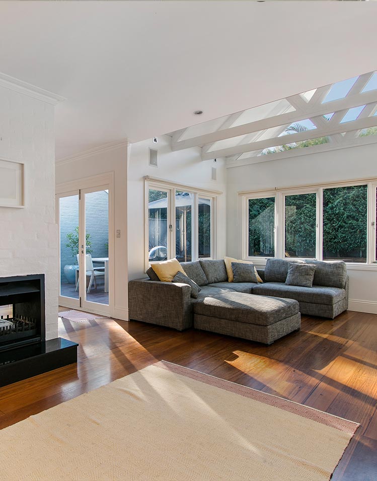 Warm toned flooring on new living room home addition