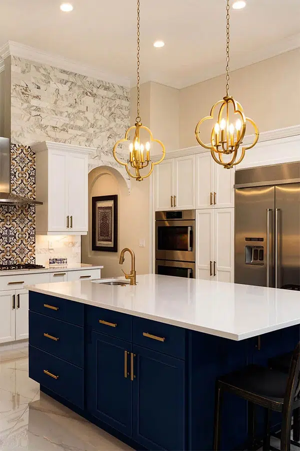 Golden kitchen with Moroccan tile backsplash and dark blue island cupboard