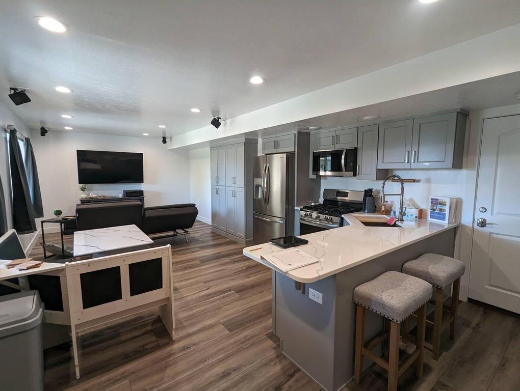 Basement remodel with open concept kitchen and island and living room