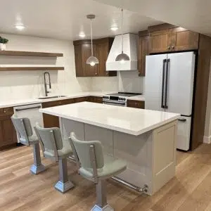Basement remodel with kitchen, showcasing white quartz countertops, vintage inspired barstools