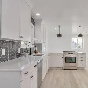 White kitchen cabinets with tile backsplash in Sandy City Utah