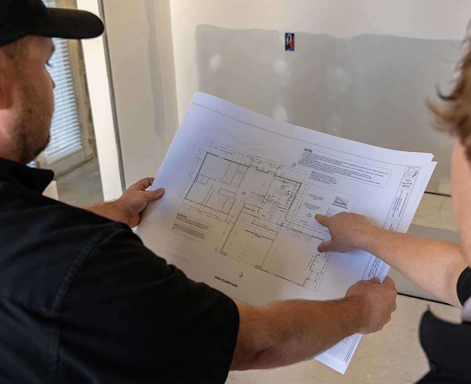 Utah Home Remodel Experts going over construction plan documents.